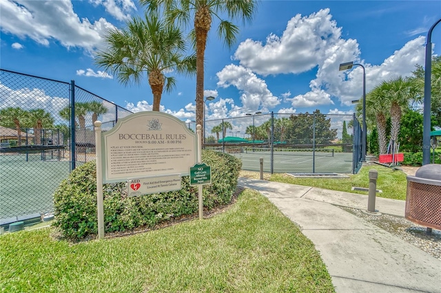 view of home's community featuring tennis court