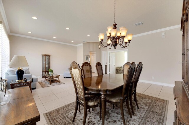 dining space featuring a chandelier, light tile patterned floors, and ornamental molding