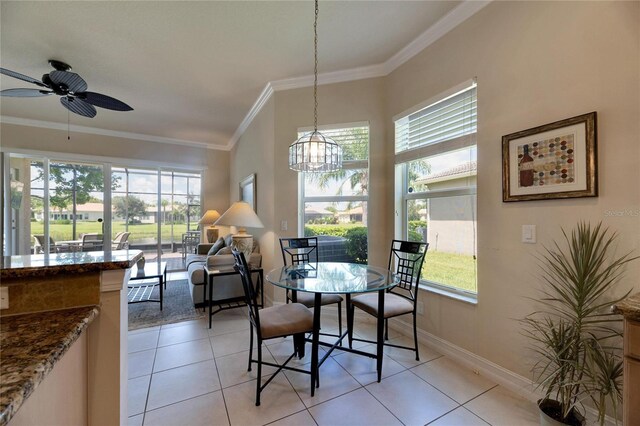 tiled dining room with ceiling fan with notable chandelier and crown molding