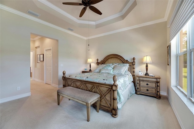 bedroom featuring a raised ceiling, ceiling fan, light colored carpet, and crown molding