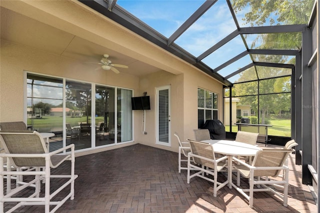 sunroom with ceiling fan and lofted ceiling