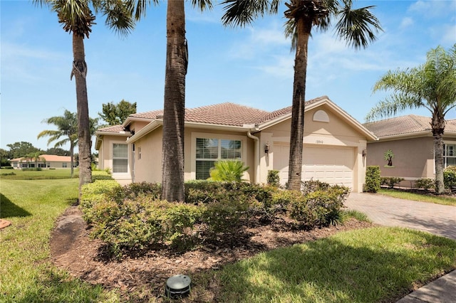 mediterranean / spanish-style home with a garage and a front yard