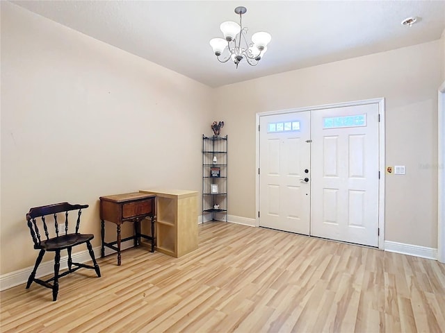 entrance foyer with light hardwood / wood-style floors and an inviting chandelier