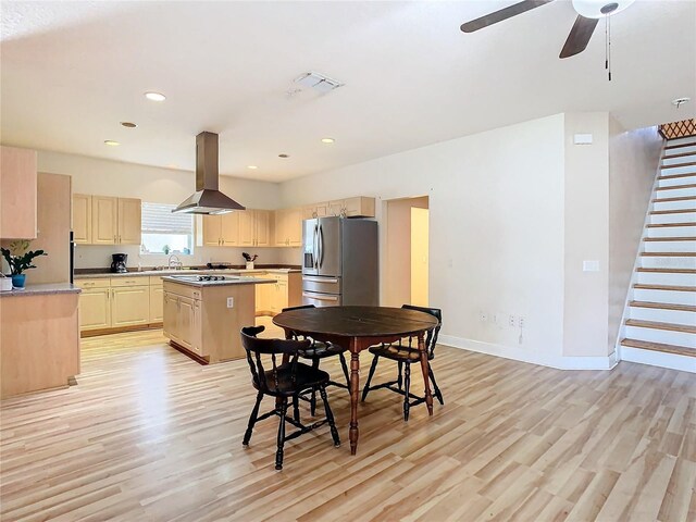 kitchen with island exhaust hood, stainless steel refrigerator with ice dispenser, light wood-type flooring, light brown cabinetry, and a center island