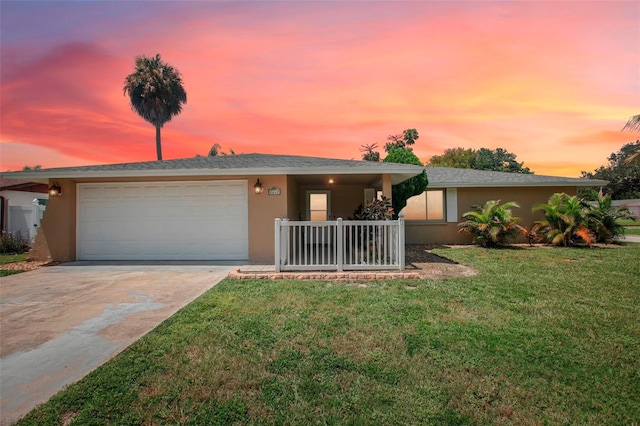 view of front facade with a garage and a lawn