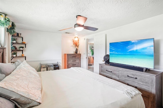 bedroom with a textured ceiling and ceiling fan