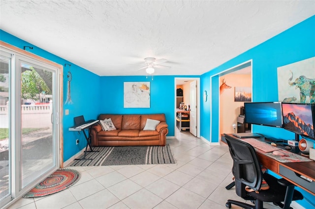 tiled office featuring a textured ceiling and ceiling fan