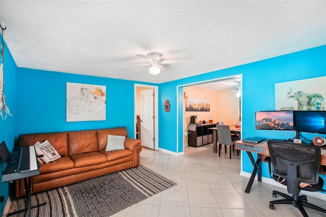 living room featuring a textured ceiling, light tile patterned floors, and ceiling fan