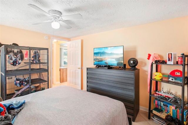 bedroom with a textured ceiling and ceiling fan