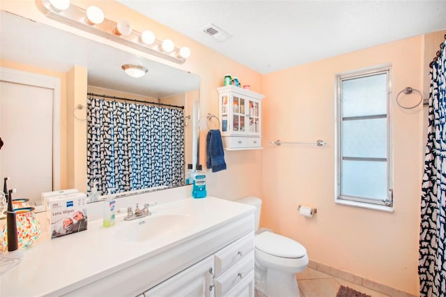 bathroom with tile patterned flooring, toilet, and vanity