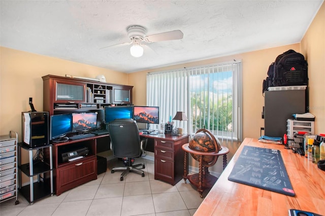 tiled office space with a textured ceiling and ceiling fan