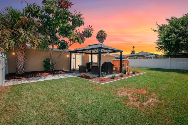 yard at dusk featuring a gazebo