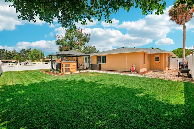 rear view of house with a lawn, a patio, and a gazebo