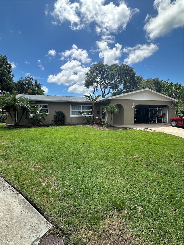 single story home featuring a front lawn and a garage