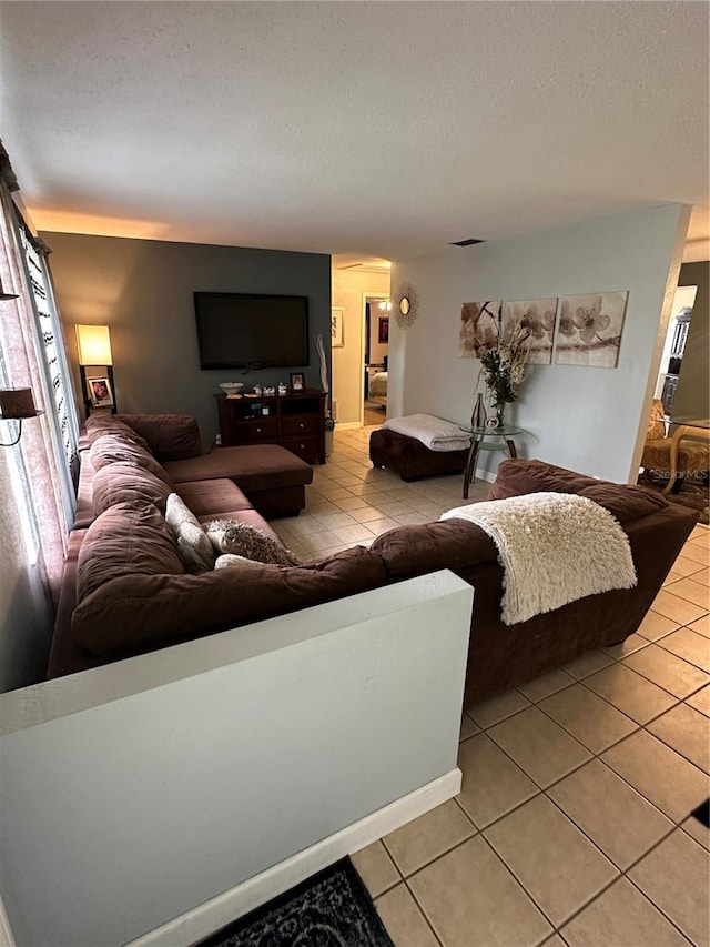 living room featuring a textured ceiling and light tile patterned flooring