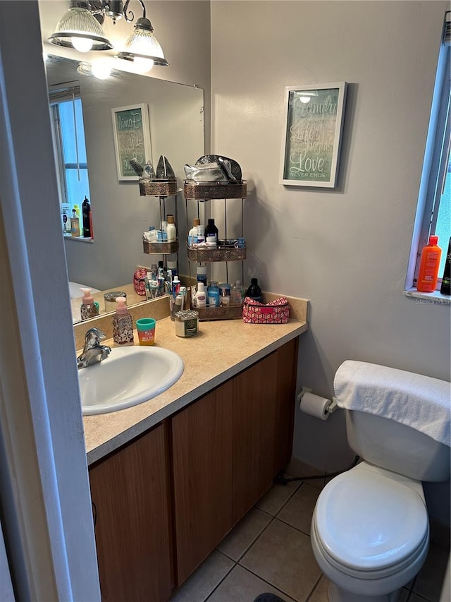 bathroom with tile patterned flooring, vanity, and toilet