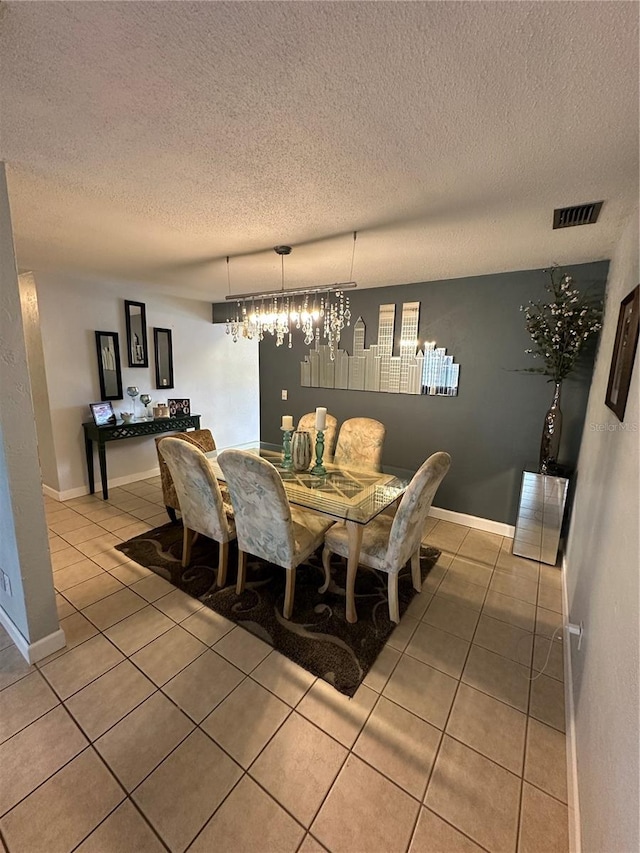 tiled dining area with a textured ceiling