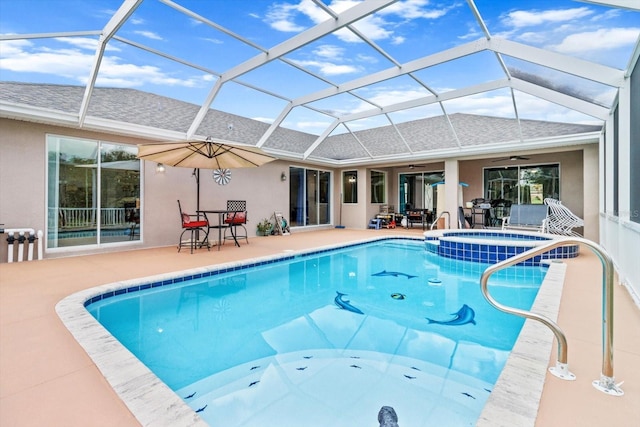 view of swimming pool with ceiling fan, a lanai, a patio, and an in ground hot tub