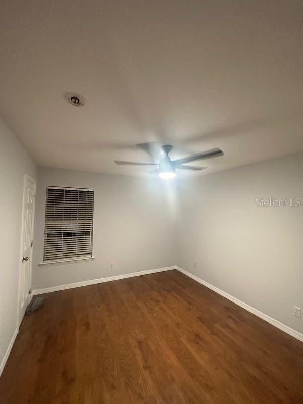 unfurnished room featuring dark hardwood / wood-style floors