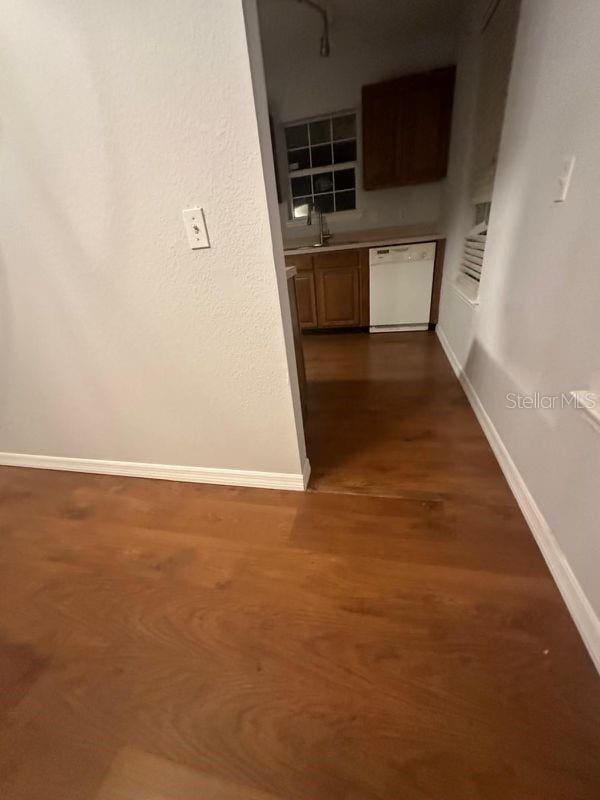 hall featuring dark hardwood / wood-style flooring and sink