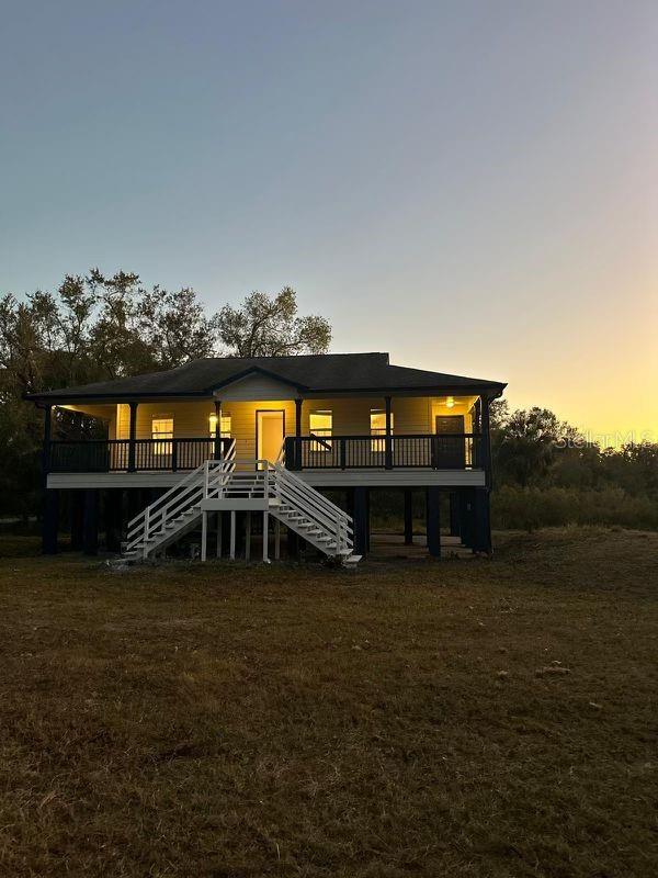 back house at dusk with a deck