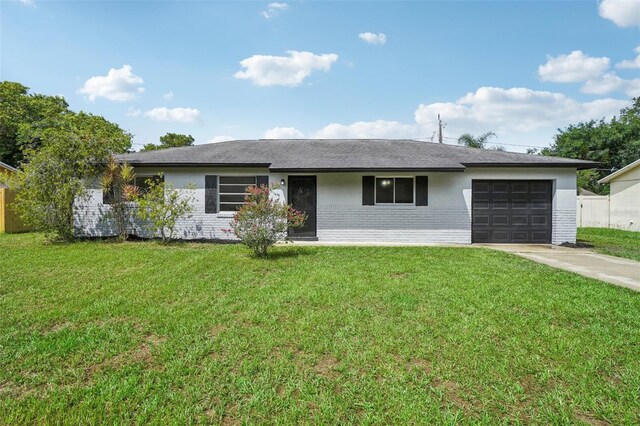 ranch-style home with a front lawn and a garage