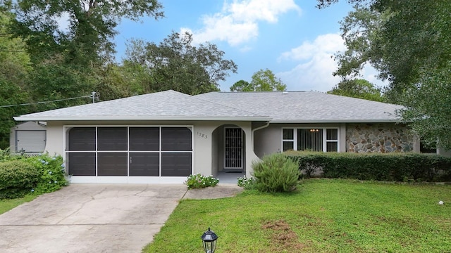 single story home with a garage and a front lawn