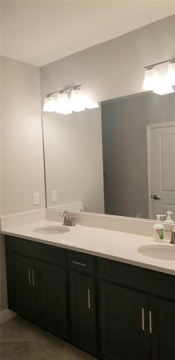 bathroom featuring tile patterned flooring and vanity