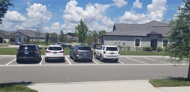 view of parking featuring a lawn