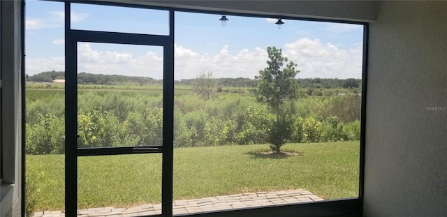 doorway to outside featuring a rural view