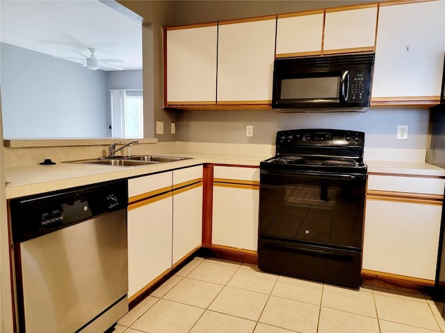 kitchen featuring light tile patterned floors, white cabinetry, sink, black appliances, and ceiling fan