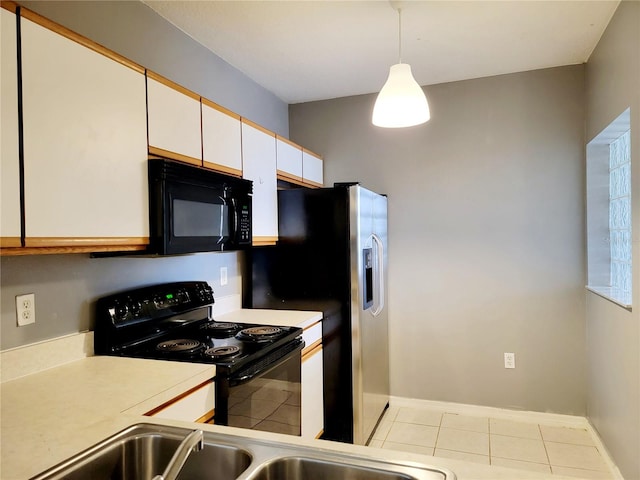 kitchen with black appliances, light tile patterned flooring, white cabinets, and hanging light fixtures