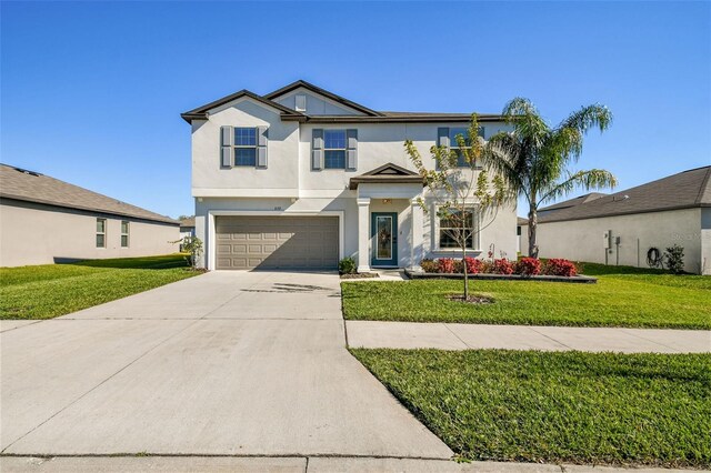 view of front of house featuring a front lawn and a garage