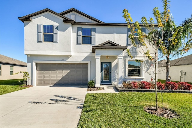 view of front of home with a front yard and a garage