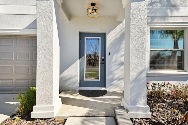 view of exterior entry featuring a garage