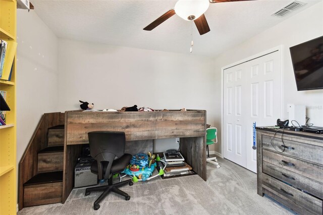 office space featuring ceiling fan and light colored carpet