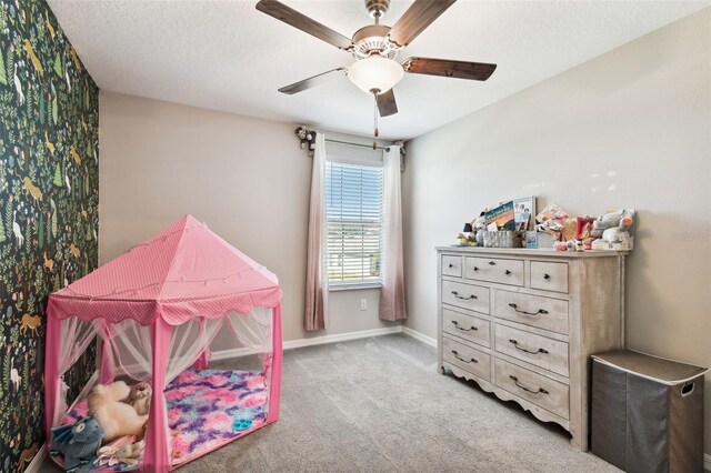 bedroom with a textured ceiling, ceiling fan, and carpet floors