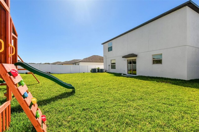 view of yard with central AC and a playground