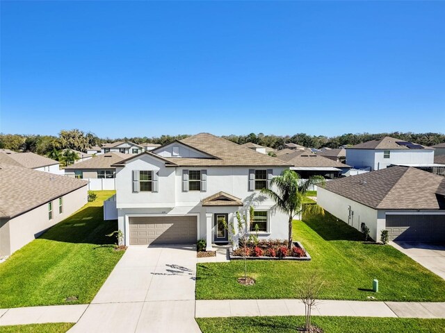 view of front of property with a garage and a front yard