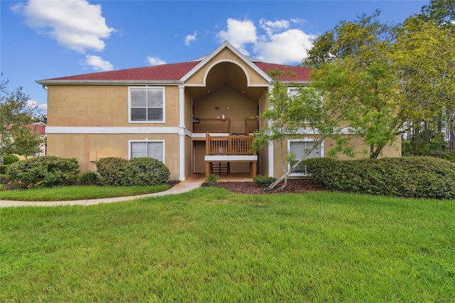 view of front of property with a front yard and stucco siding