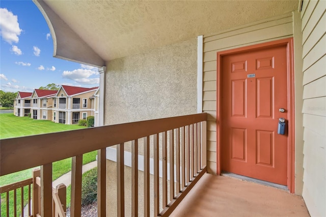 doorway to property with a balcony and stucco siding