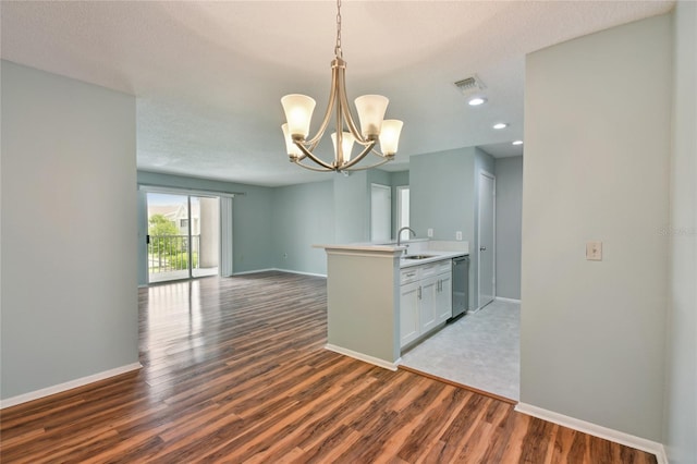 kitchen with visible vents, stainless steel dishwasher, dark wood-type flooring, open floor plan, and a sink