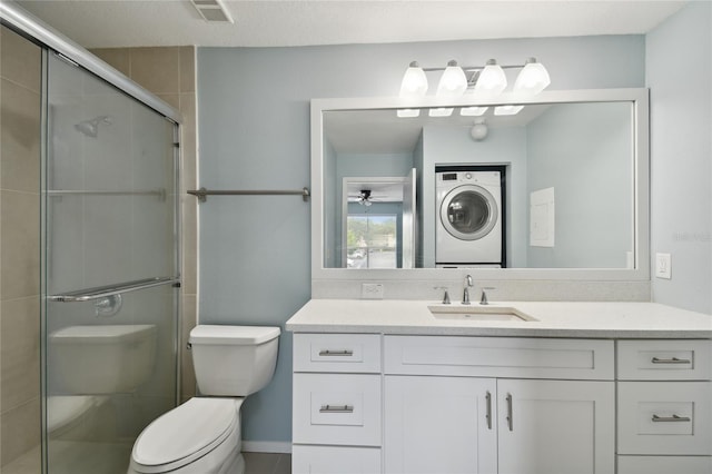 bathroom with visible vents, stacked washer and clothes dryer, toilet, and a shower stall