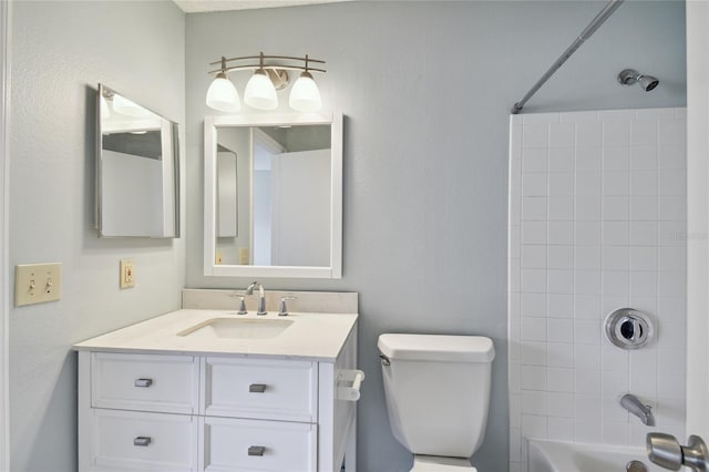 bathroom featuring toilet, shower / bathtub combination, and vanity