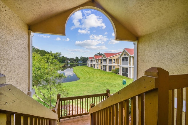 view of yard featuring a water view and a balcony