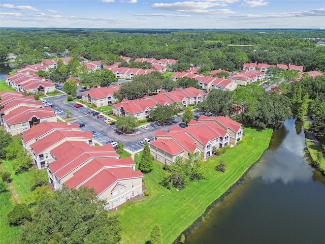 bird's eye view with a residential view, a water view, and a wooded view