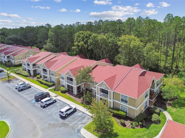 drone / aerial view with a wooded view