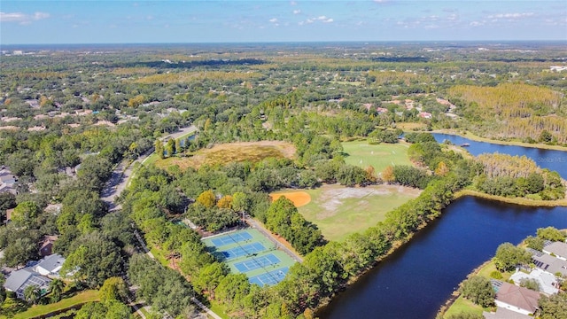 bird's eye view with a water view and a wooded view