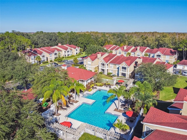 birds eye view of property featuring a residential view and a wooded view