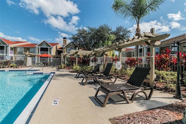 pool featuring a residential view, a patio area, fence, and a pergola